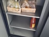 a shelf with bottles and condiments on it in a kitchen
