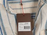 a close up of a blue and white striped shirt with a tag on it
