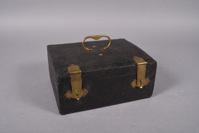 a black suitcase with gold handles on a white surface