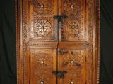 an old wooden cabinet with two drawers and a door