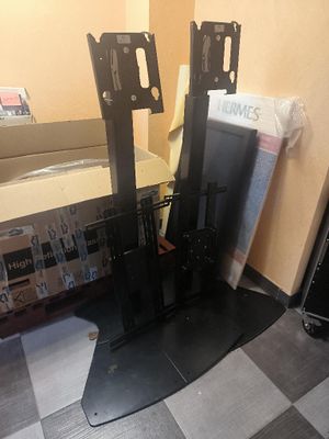 two televisions sitting on top of a table in a room