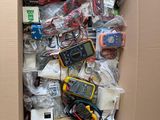 a cardboard box filled with electronic devices and wires