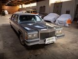 a car that is parked in a garage next to other cars