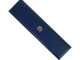 a close up of a blue bookmark with a gold emblem on it