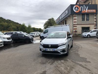 the white car is parked in the parking lot outside of the building