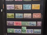 many different stamps on a black folder on a table