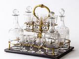 bottles and glasses on a tray on a white background