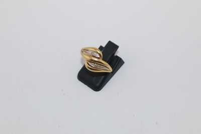 a close up of a gold ring on a white surface