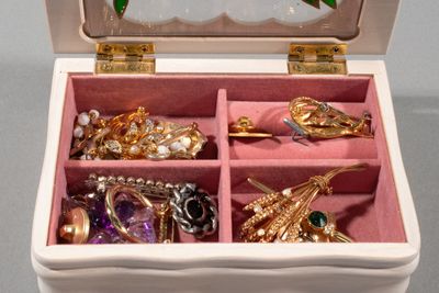 a white box with a bunch of jewelry inside of it