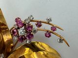 a close up of a brooch with a bunch of flowers