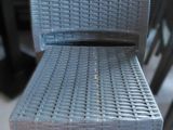 a grey chair that is sitting on a wooden table