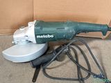 a green and white electric polisher sitting on the floor