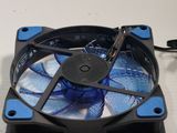 a blue fan that is sitting on top of a table