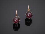 a pair of ruby and diamond earrings