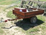 a small trailer that is sitting in the grass