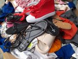 a cardboard box full of shoes and clothing on the floor