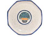 a close up of a plate with a flower pot on it