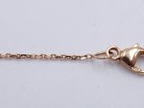 a gold chain with a heart charm on it