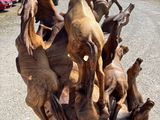 sculpture of a group of horses standing on top of a pile of wood