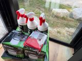 boxes of cleaning products sit on a window sill in front of a window