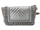 silver leather handbag with chain strap and flap closure