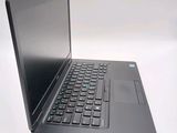 a laptop computer sitting on a table with a keyboard