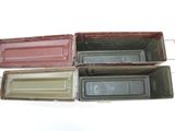 several different colors of tinned containers sitting on top of a white surface
