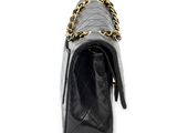 a black chanel bag with a gold chain strap