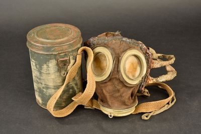 an old gas mask and a canister on a table