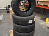 four tires stacked on top of each other in a warehouse