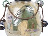 a vase with a handle that has a picture of a cat on it