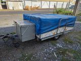 a trailer with a tarp on the back of it