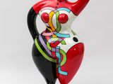 red and black ceramic sculpture of a woman holding a heart