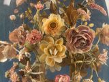 a glass dome with a bunch of flowers inside of it