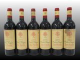 six bottles of red wine are lined up in a row