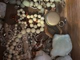 a wooden box filled with lots of jewelry on a table