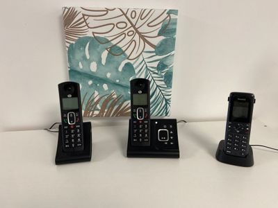 three phones that are sitting on a table