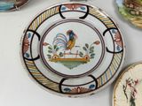 a plate with a rooster painted on it on a table