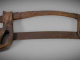 an old wooden hand saw with a wooden handle on a white surface