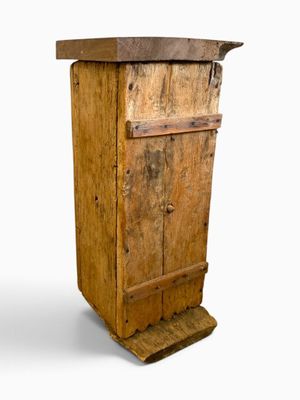 a wooden cabinet with a door on top of it