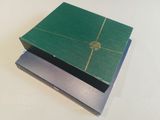 a green box that is sitting on top of a white table