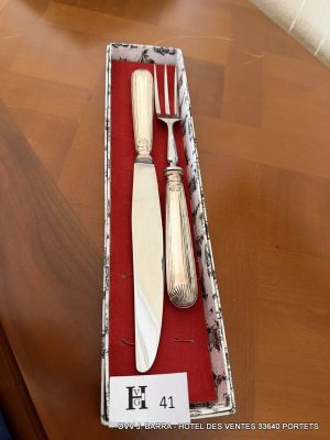 a knife, fork and spoon in a box on a table