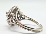 a close up of a silver ring with a flower design on it