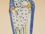 a close up of a figurine of a woman holding a child