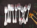 a lot of forks and spoons that are on a table