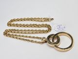 a close up of a gold chain with two rings on it