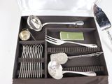 a box with silverware in it on a white table