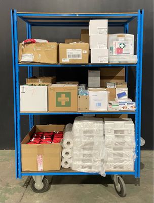 many boxes and packages on a blue shelf in a warehouse