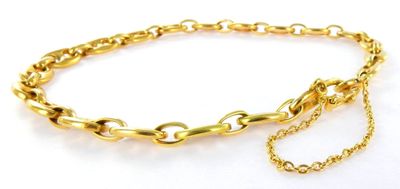 a close up of a gold chain bracelet on a white background