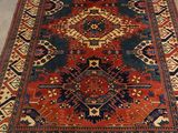 an oriental rug with a red, blue, and yellow design